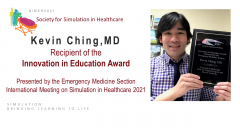 Dr. Kevin Ching Holding Up Award